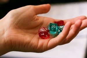 Image of hand holding a dice set